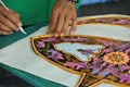 Malaysian kite maker working on a kite in his workshop Royalty Free Stock Photo